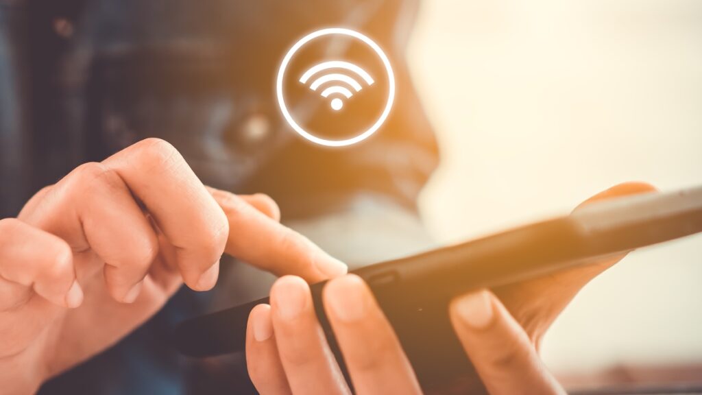 Woman,Hand,Using,Smartphone,With,Wifi,Icon,In,Cafe,Shop